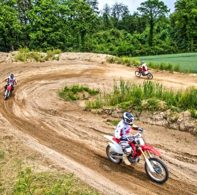 Three riders on the MX-Academy motocross track