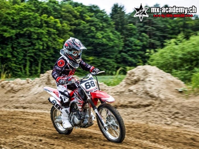Teen motocross rider with number 68 on the track